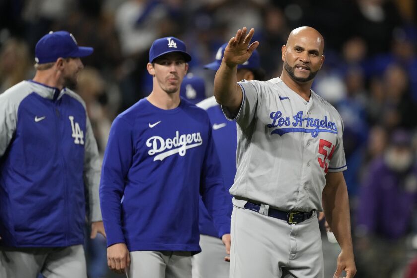 Los Angeles Dodgers' Albert Pujols waves to fans after the 10th inning of a baseball game against the Colorado Rockies Tuesday, Sept. 21, 2021, in Denver. The Dodgers won 5-4 behind an RBI-single hit by Pujols in the 10th inning. (AP Photo/David Zalubowski)
