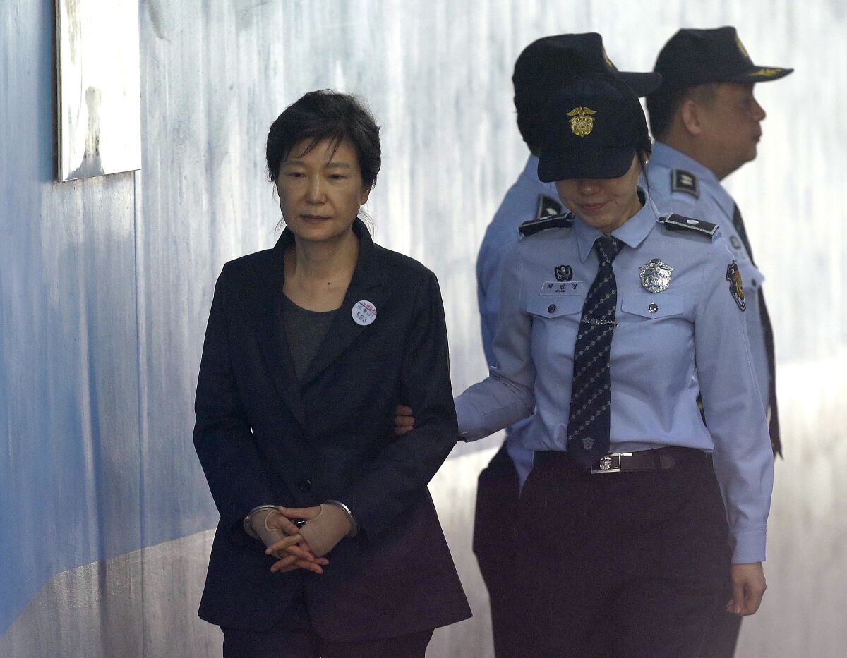 FILE - In this Oct. 10, 2017, file photo, former South Korean President Park Geun-hye, left, arrives to attend a hearing on the extension of her detention at the Seoul Central District Court in Seoul, South Korea. South Korea’s top court upheld 20-year prison term for Park over corruption on Thursday, Jan. 14, 2021. (AP Photo/Ahn Young-joon, File)