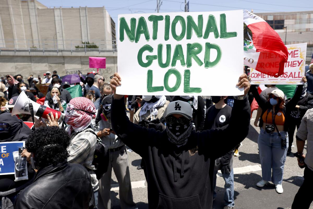 A protester holds up a sign