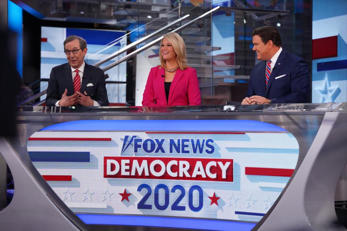 Three anchors behind a desk that says "Fox News Democracy 2020"