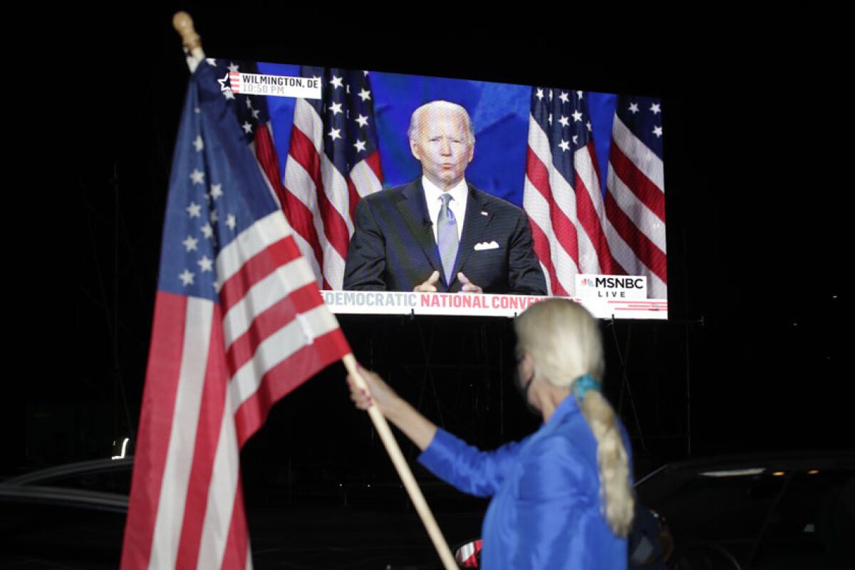 Presidential nominee Joe Biden's convention speech is broadcast at a drive-in theater watch party Thursday in Washington. 
