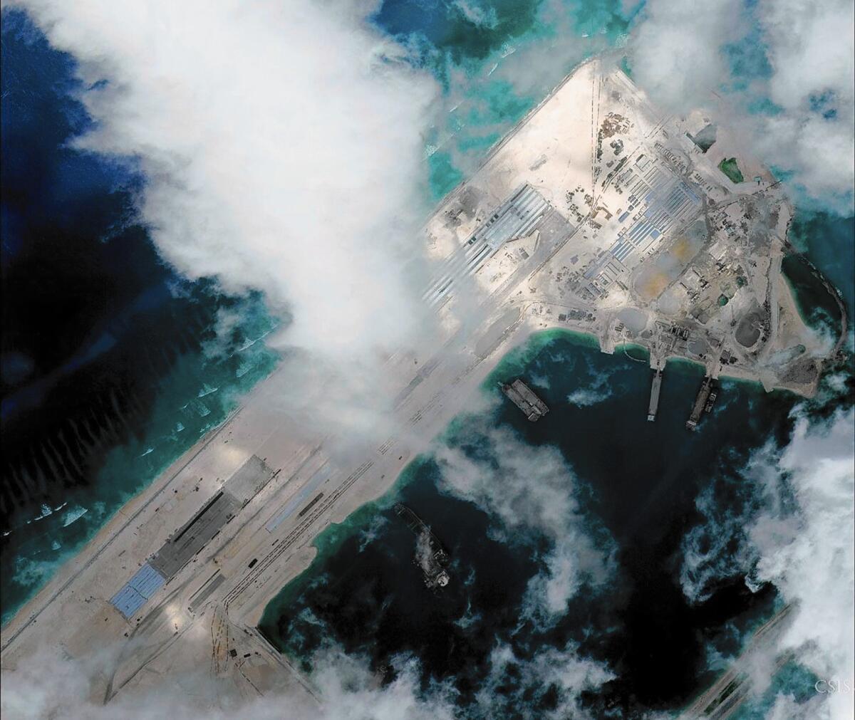 A satellite image shows an airstrip under construction at Fiery Cross Reef in the South China Sea. A U.S. Navy plane flying nearby received eight warnings from the Chinese military.