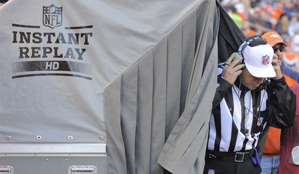 Referee Al Riverson steps out of the instant-replay tent during an NFL football game between the Denver Broncos and the Cleveland Browns in December 2012.