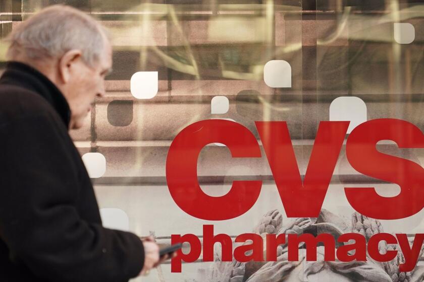 Pedestrians walk past a CVS pharmacy in Washington, DC on December 3, 2017. US pharmacy chain CVS has agreed to buy medical insurer Aetna for around $69 billion, according to reports. / AFP PHOTO / MANDEL NGANMANDEL NGAN/AFP/Getty Images ** OUTS - ELSENT, FPG, CM - OUTS * NM, PH, VA if sourced by CT, LA or MoD **