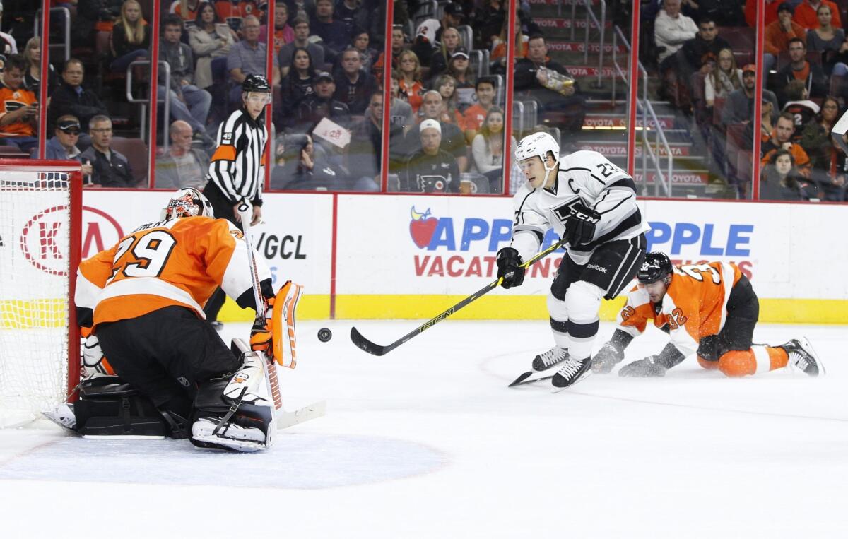 Dustin Brown puts a shot on Flyers goalie Ray Emery during the first period of the Kings' 3-2 loss to Philadelphia in overtime.