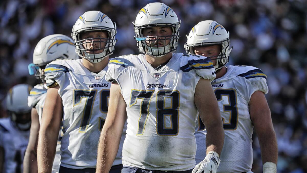 Chargers offensive linemen Kenny Wiggins, left, Michael Schofield and Spencer Pulley on the field during action against the Chiefs at StubHub Center.