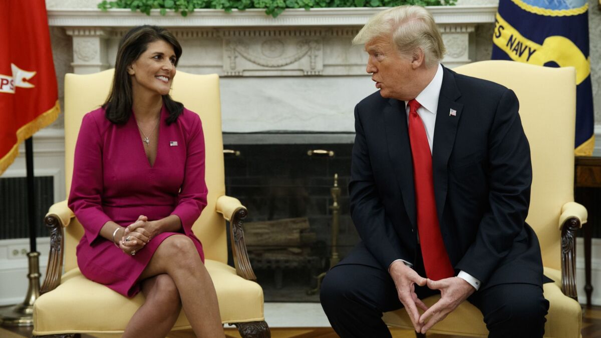 President Donald Trump meets with outgoing U.S. Ambassador to the United Nations Nikki Haley in the Oval Office of the White House in Washington on Oct. 9.