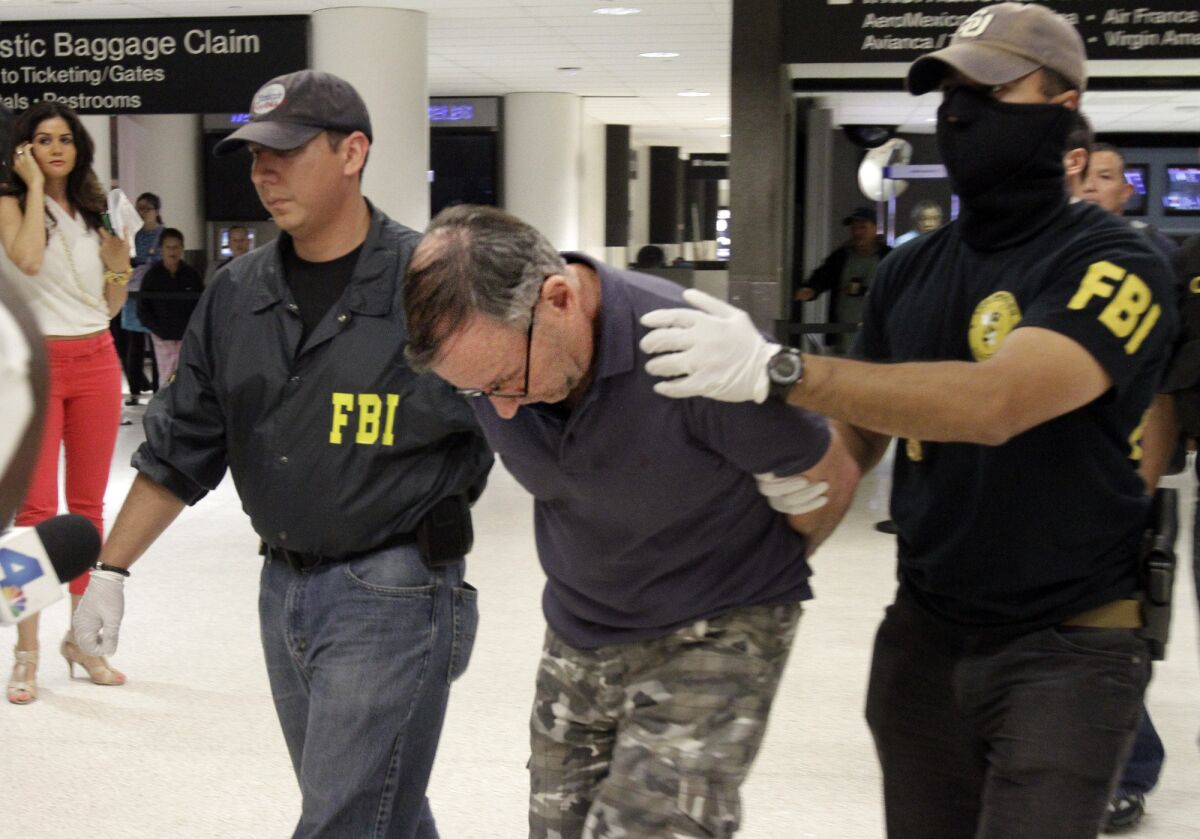 Walter Lee Williams is taken into custody in June 2013 by the FBI at Los Angeles International Airport.