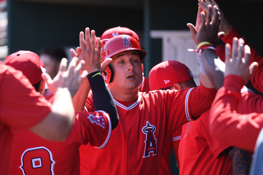 Angels' Matt Thaiss celebrates with teammates in the dugout.
