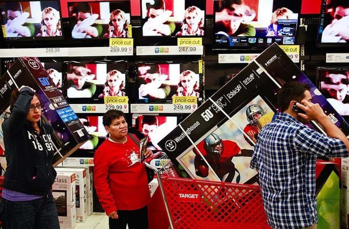 Black Friday shoppers at a Target in Burbank. Christmas gifts will cost consumers $770 each on average this year, a survey says.