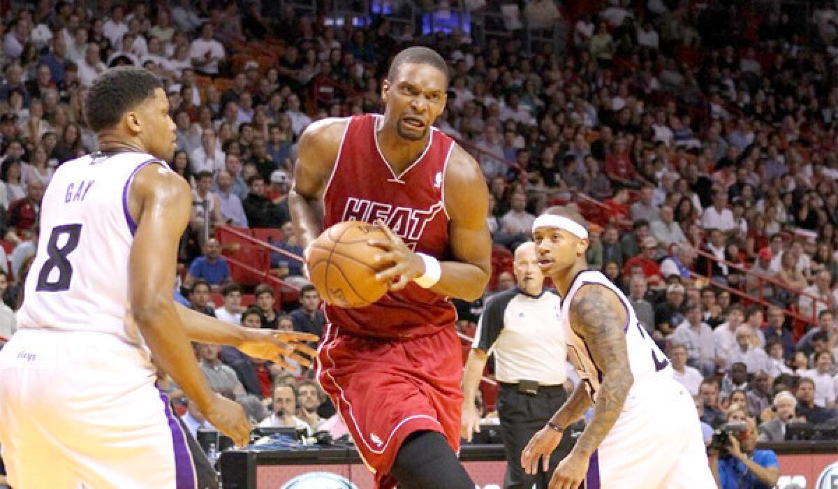Chris Bosh drives through the Sacramento Kings porous defense Friday night en route to a 122-103 win. Bosh and the Heat will face Lakers, who are without Kobe Bryant, on Christmas Day.