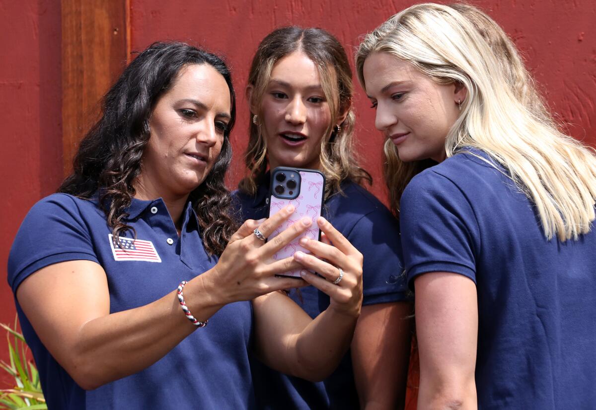 Olympic women's water polo team captain Maggie Steffens, left, takes selfies with her teammates.