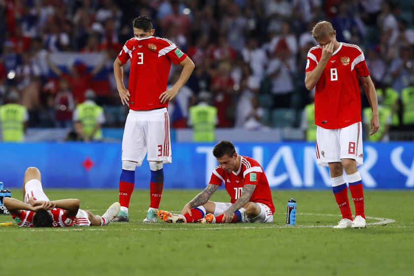 Russia national soccer team players react at the end of the quarterfinal match at the 2018 soccer World Cup