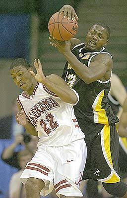 Alabama's Ronald Steele and Wisconsin-Milwaukee forward Joah Tucker fight for possession of the ball.