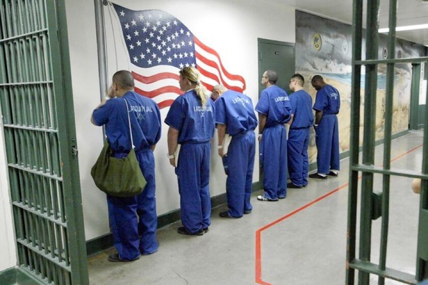 Inmates wait in a section of Men's Central Jail in downtown Los Angeles. Federal authorities are said to be investigating beatings of inmates there.