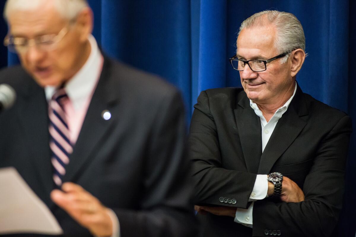Los Angeles County Fair Assn. chief executive James Henwood Jr., right, listens to County Supervisor Michael D. Antonovich, left, as they promote the annual event.