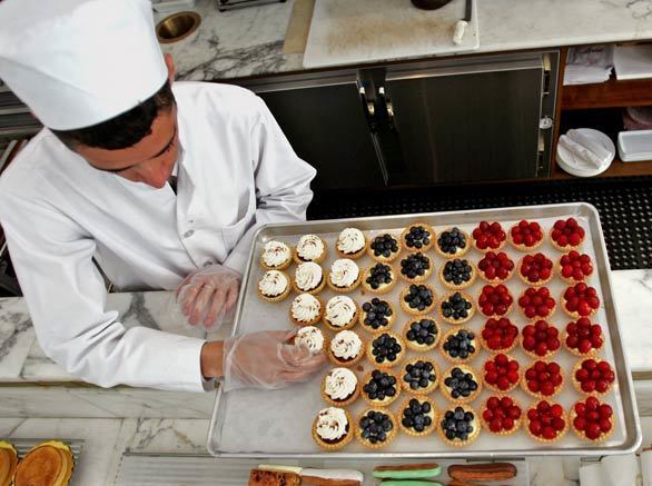 Donavan Cox prepares mini tarts for display at the Bottega Louie restaurant in downtown Los Angeles.