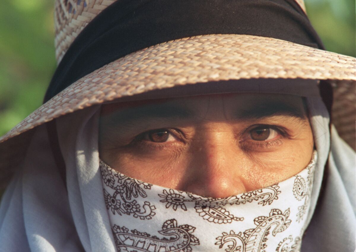 Maria Ambris, a Coachella Valley agricultural worker, wears a hat and bandanna to protect her from the sun and pesticides on June 4, 1996.