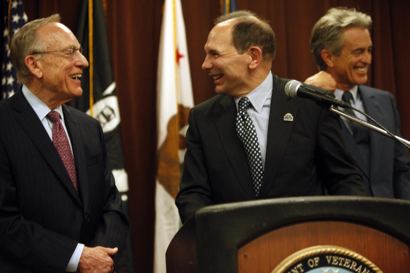 Veterans Affairs Secretary Robert A. McDonald, center, shares a light moment with attorneys Ron Olson, left, and Bobby Shriver after announcing a settlement to use the agency's sprawling West L.A. campus to help end homelessness among veterans in Los Angeles County.
