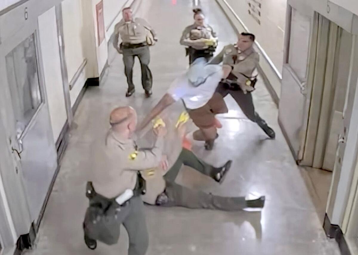 Inmate being subdued by San Bernardino County sheriff’s deputies in a hallway at the West Valley Detention Center