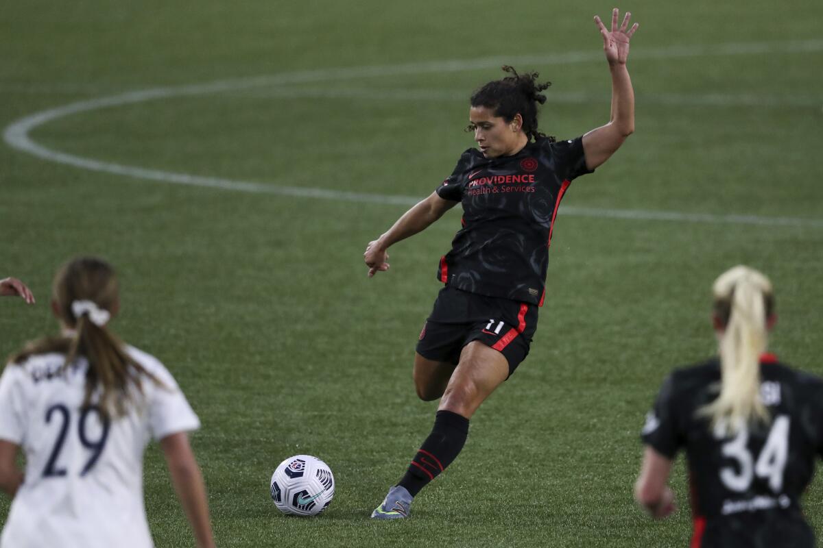 Portland Thorns player Rocky Rodriguez passes to a teammate during a game.
