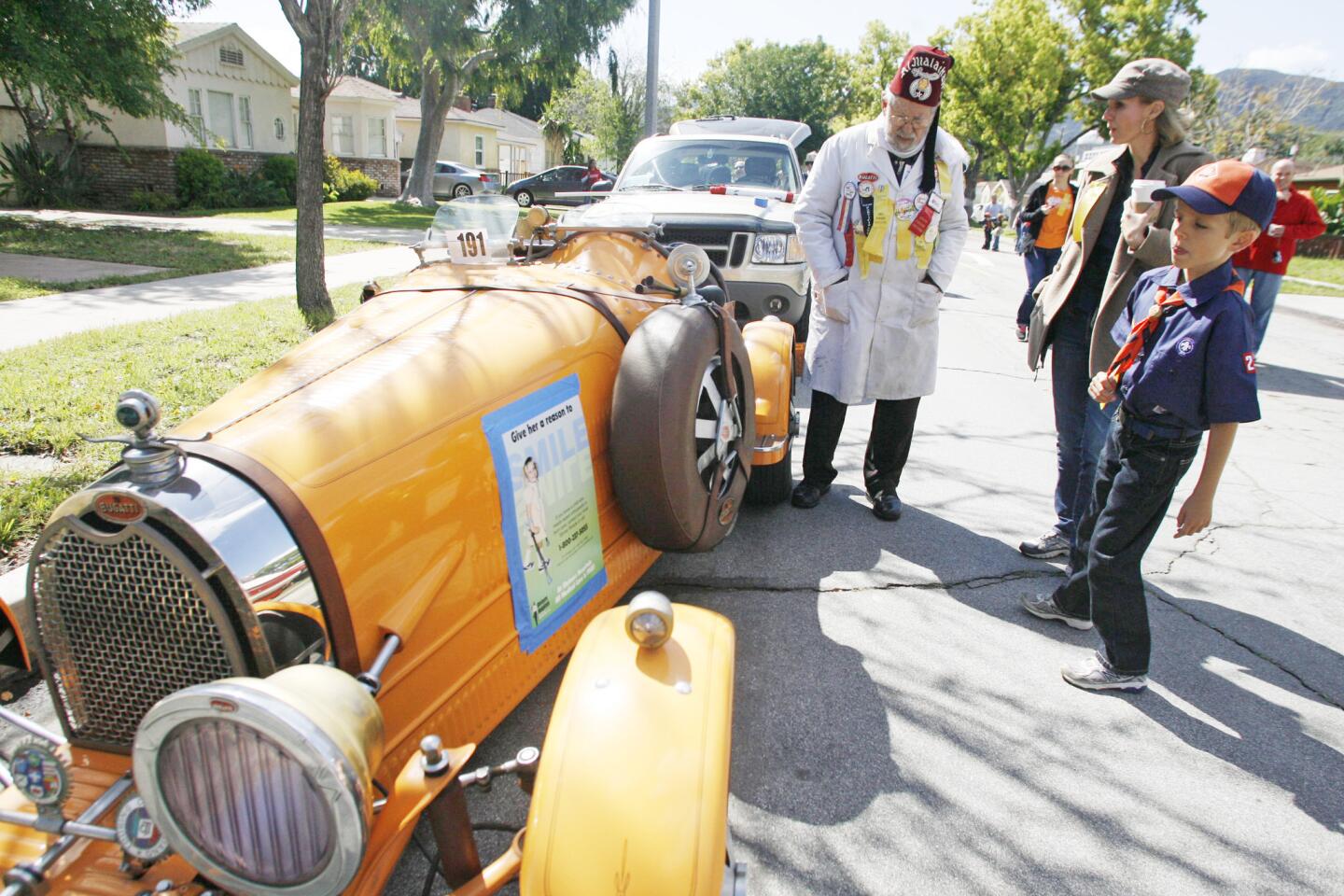 Dr. Bernard Harris, from left, shows off his 1927 Bugati to Gordana Lewis, and her son, Brenton, 7, during Burbank on Parade, which took place on Olive Ave. between Keystone St. and Lomita St. on Saturday, April 14, 2012.