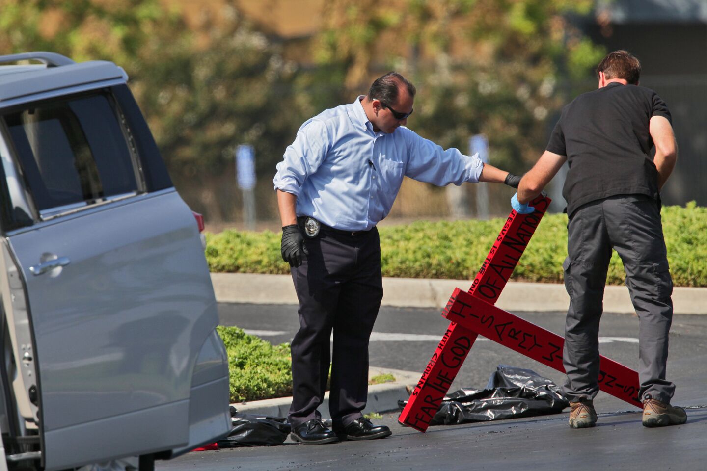 A former Transportation Security Administration screener suspected of making threats to terminals at Los Angeles International Airport was arrested just before midnight while sitting in a van that was parked at the Harvest Church, at Urban Street and Arlington Avenue in Riverside. FBI and Riverside police investigators gather evidence from the van and around it on Wednesday morning.