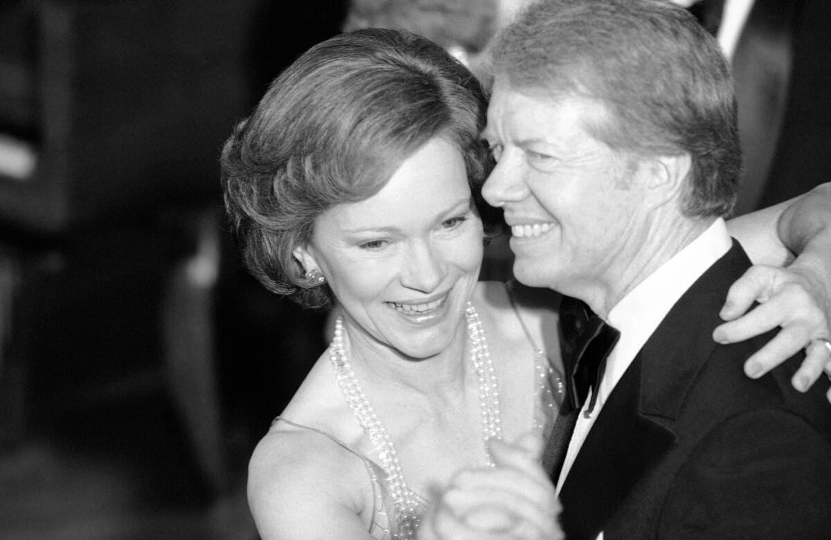 President Carter and First Lady Rosalynn Carter dance with their arms around each other in 1978.