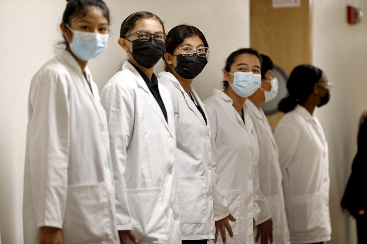 Students from King/Drew Magnet High School of Medicine and Science wait for the arrival of Surgeon General Vivek H. Murthy