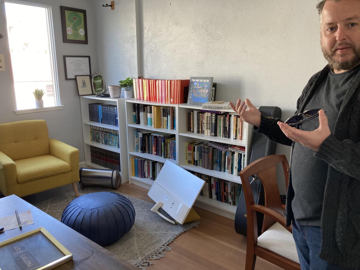 Costa Mesa First UMC Pastor Matt Hambrick shows the chair in which a burglary suspect was found Sunday morning.