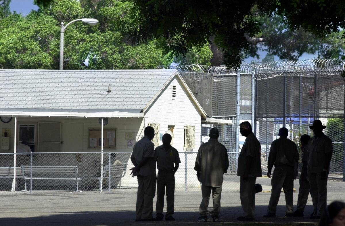 Inmates in shadow outdoors at Patton State Hospital.