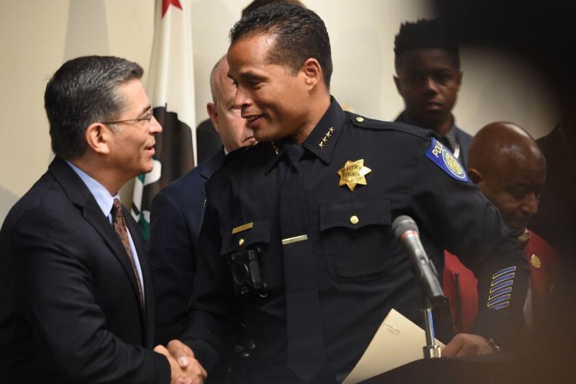 Sacramento Police Chief Daniel Hahn (R) shakes hands with California Attorney General Xavier Becerra (L) after a press conference about the investigation of the shooting death of Stephon Clark in Sacramento, California on March 27, 2018. Clark, who was unarmed, was shot and killed by police officers at his grandmother's home. (Josh Edelson/AFP/Getty Images) ** OUTS - ELSENT, FPG, TCN - OUTS **