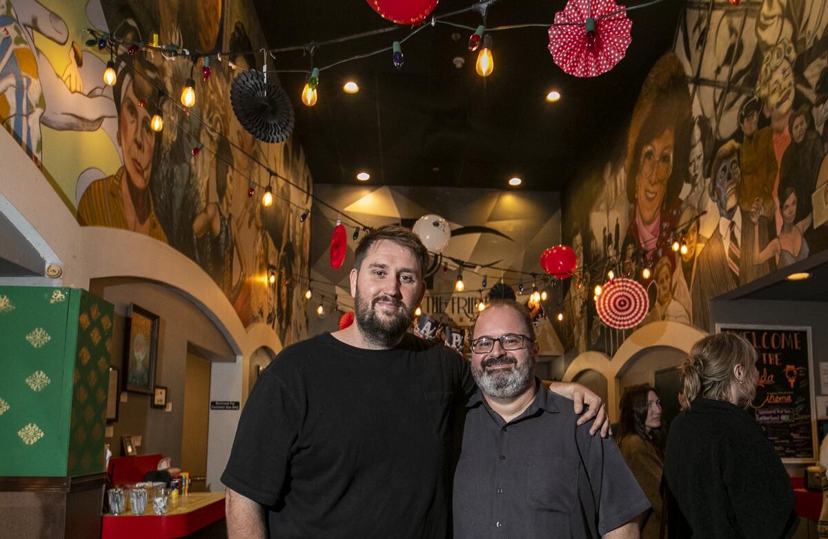 Trevor Dillon, left, and Logan Crow, with the Frida Cinema.