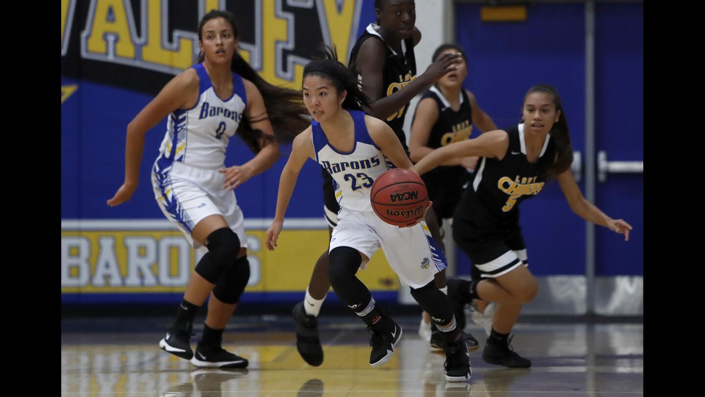 Fountain Valley High's Caitlin Okawa (23) dribbles after recovering a loose ball against Santa Fe during the first half in a nonleague game on Tuesday, November 20, 2018.