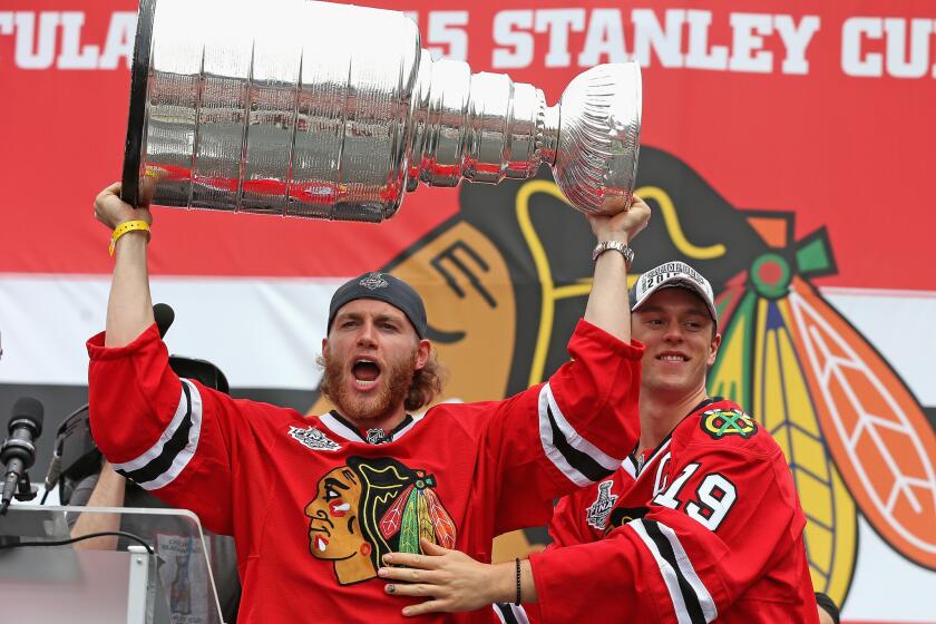 Patrick Kane, left, and Jonathan Toews celebrate with the crowd during the Chicago Blackhawks' Stanley Cup championship rally at Soldier Field on June 18.