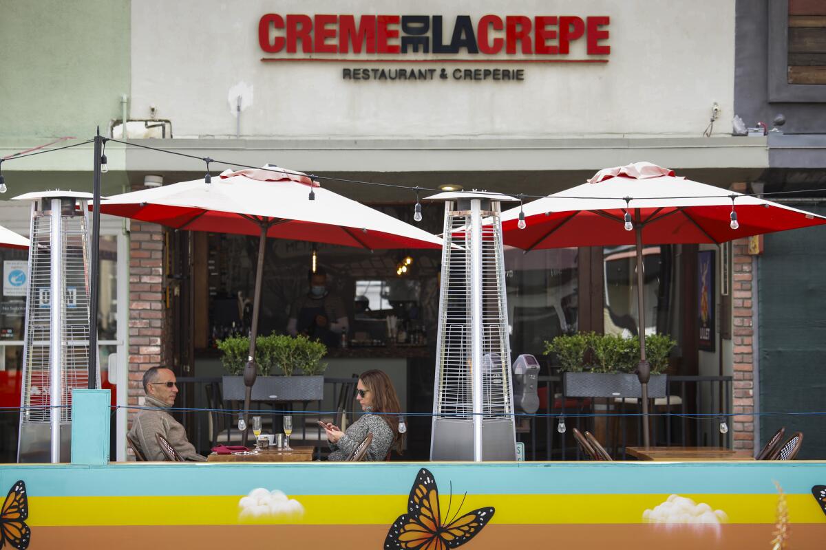 A couple dines outside in Hermosa Beach.