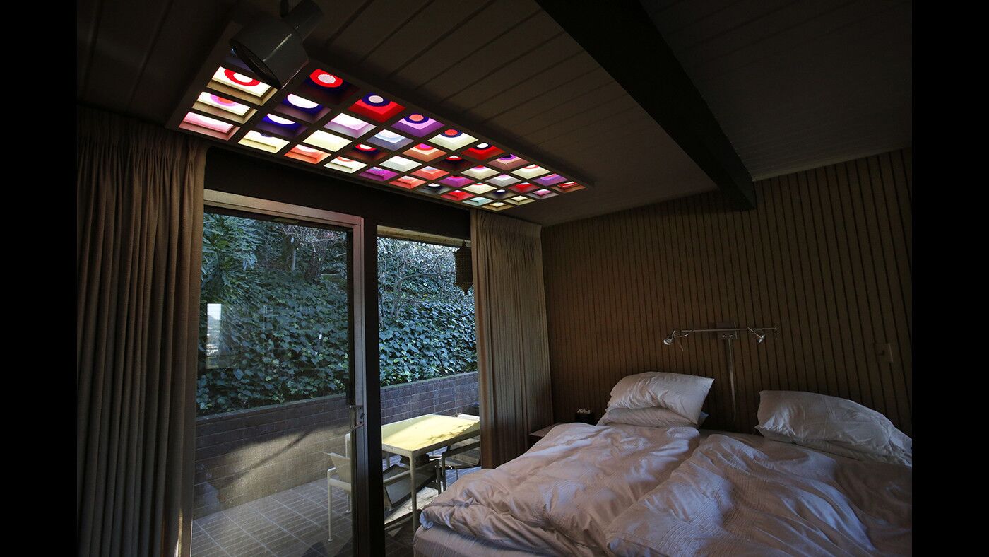 In the bedroom, a skylight with tiles made by the original owner Flemming Drefeld, who commissioned the home.