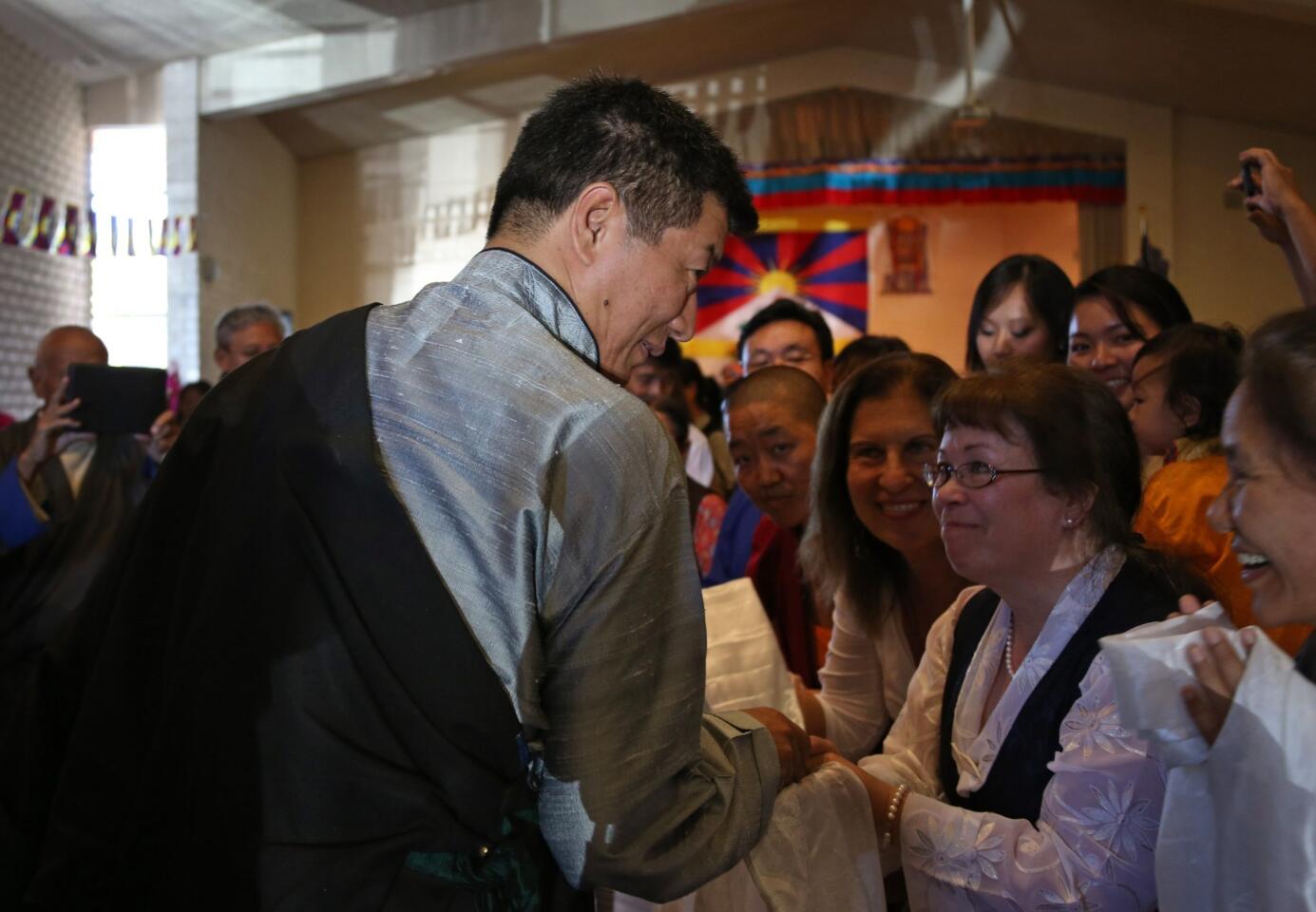 Lobsang Sangay, the prime minister of the Tibetan exile government, greets members of the Southern California Tibetan community on Sunday as he arrives at Covenant Presbyterian Church in Los Angeles to deliver an address.
