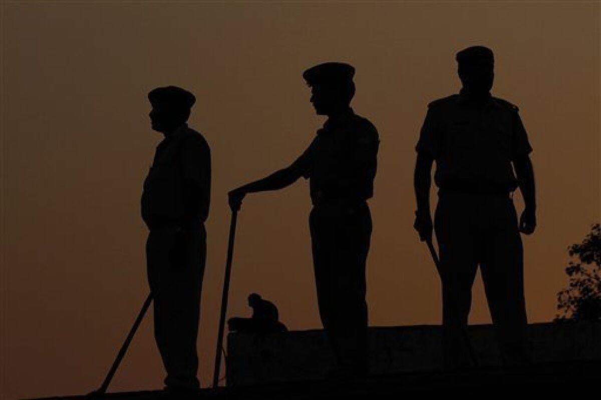 Indian security personnel stand on roof of buildings in Ayodhya, India, Wednesday, Sept. 29, 2010. The Allahabad High Court is scheduled to rule Thursday in the 60-year-old case on whether the site in the town of Ayodhya should be given to the Hindu community to build a temple to the god Rama or returned to the Muslim community to rebuild the 16th-century Babri Mosque that was razed by Hindu hard-liners in 1992. (AP Photo/Rajesh Kumar Singh)