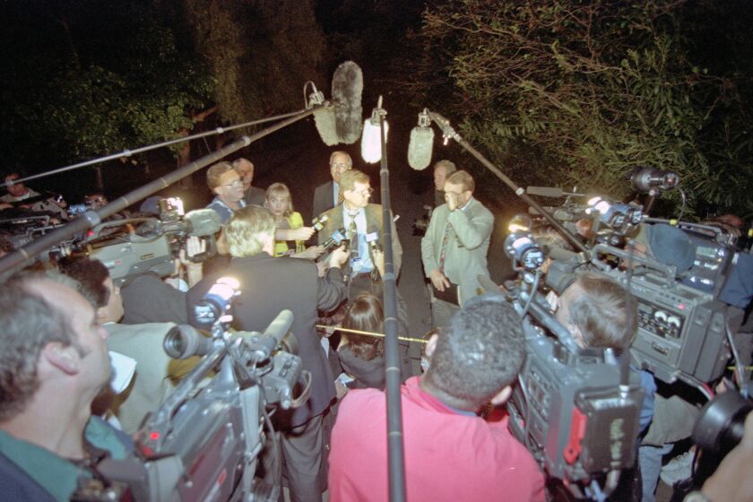 San Diego County Sheriff's Cmdr. Alan Fulmer (center) briefs reporters about the discovery of 39 bodies of Heaven's Gate members inside a Rancho Santa Fe mansion on March 26, 1997.