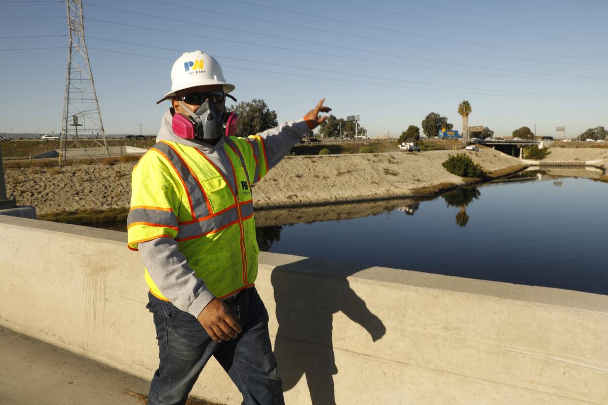 Crews from the Los Angeles County Department of Public Works prepare to work on the Dominguez Channel 