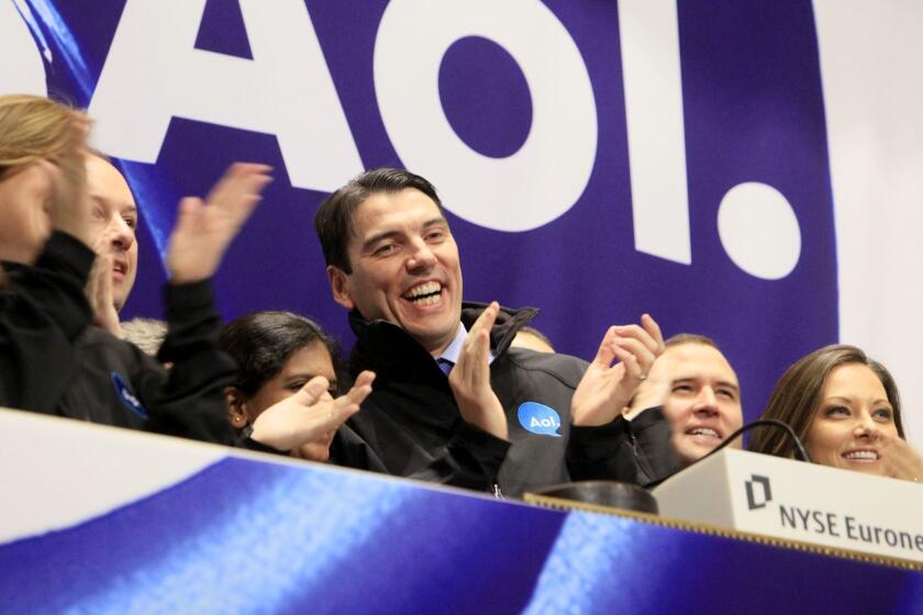 FILE - In this Dec. 10, 2009 file photo, AOL Chairman and CEO Tim Armstrong, center, applauds during opening bell ceremonies of the New York Stock Exchange. Verizon on Tuesday, May 12, 2015 announced it is buying AOL for about $4.4 billion, advancing the telecom's push in both mobile and advertising fields. (AP Photo/Richard Drew, File)