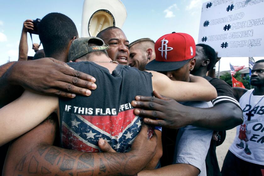 All Lives Matter protesters come together for a group hug with Black Lives Matter activists in Dallas on Sunday.