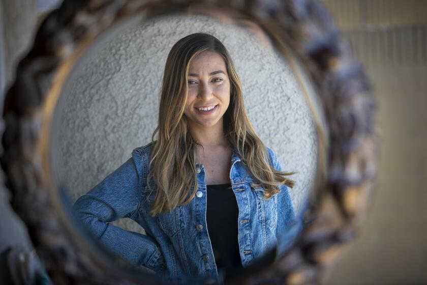 WESTMINSTER, CA -- FRIDAY, MAY 8, 2020: After nearly six years waiting for a kidney transplant, Amar Abu-Samrah, 24, shown at her parents' Westminster home, found out late last year that she was near the top of the list. In mid-March, the coronavirus outbreak forced the transplant center to postpone most procedures. Photo taken in Westminster, CA, on May 8, 2020. Since then, Abu-Samrah has been trying to limit her potential for exposure to the novel coronavirus as much as possible: She's doing more doctor appointments over the phone and avoiding hospital waiting rooms when she goes in for lab work. The Westminster resident, who lives with her parents, is even limiting contact with family members to mealtimes, knowing her kidney failure puts her at high risk if she contracts COVID-19. "It makes me anxious," she said. "I'm like, OK, how much longer do I have to wait?" (Allen J. Schaben / Los Angeles Times)