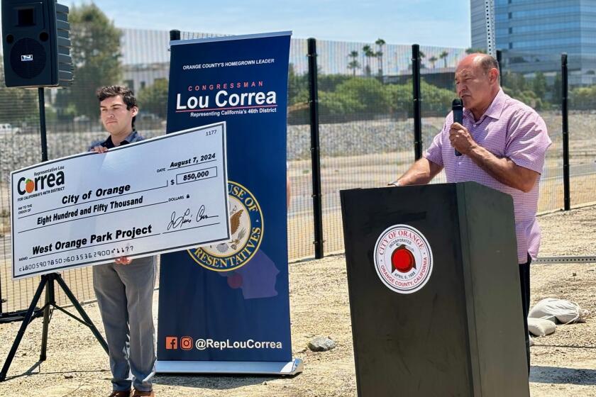 Representative Lou Correa (CA-46) presents a check to help build the West Orange Park.