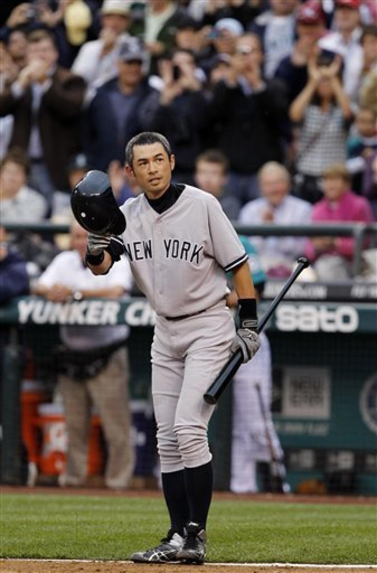 New York Yankees' Ichiro Suzuki doffs his batting helmet as fans cheer as he steps up to bat against the Seattle Mariners in the third inning of a baseball game Monday, July 23, 2012, in Seattle. The Mariners announced earlier in the day that Suzuki, who has played with the Mariners since 2001, was traded to the Yankees. (AP Photo/Elaine Thompson)