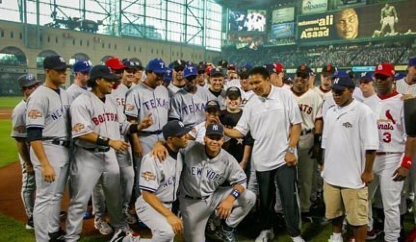 Members of the 2004 NL and AL All-Star teams pose with Muhammad Ali before the game played at Houston's Minute Maid Field.