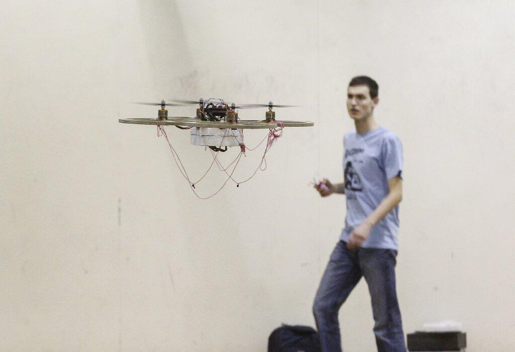 Caltech mechanical engineering student Christopher Culpepper flies a robot designed by his team, the Soup Nazis, at an engineering design competition in Pasadena.