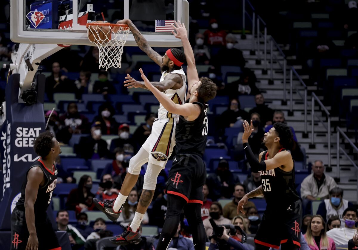 New Orleans Pelicans forward Brandon Ingram (14) dunks over Houston Rockets center Alperen Sengun (28) during the first quarter of an NBA basketball game in New Orleans, Tuesday, Feb. 8, 2022. (AP Photo/Derick Hingle)