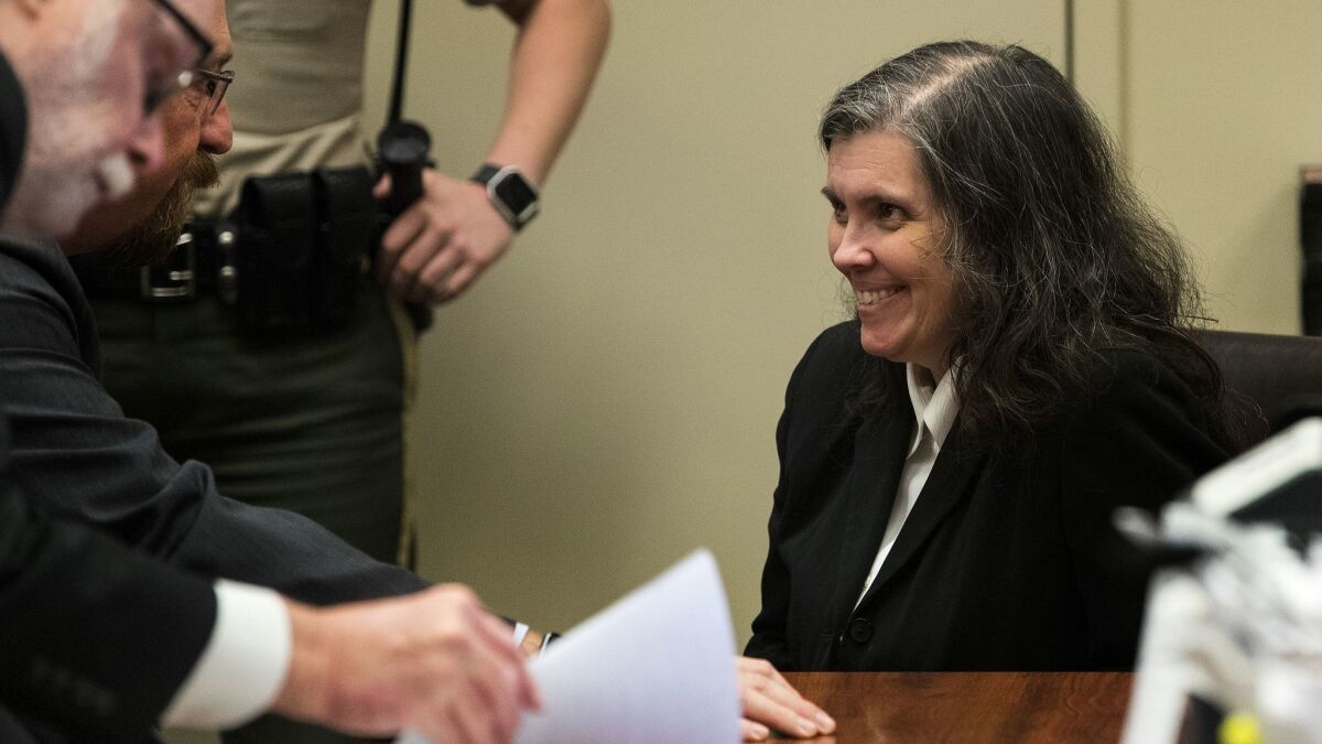Louise Turpin laughs while consulting with her attorney Jeff Moore. She and her husband David Turpin were barred from having any further contact with their 13 children during a court hearing at the Riverside Hall of Justice on Wednesday.